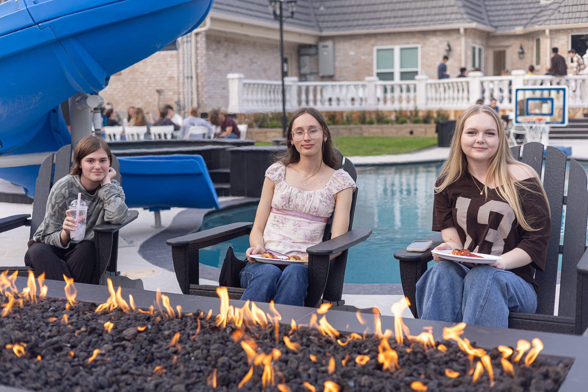 YAF Houston students relaxing by the pool fire pit