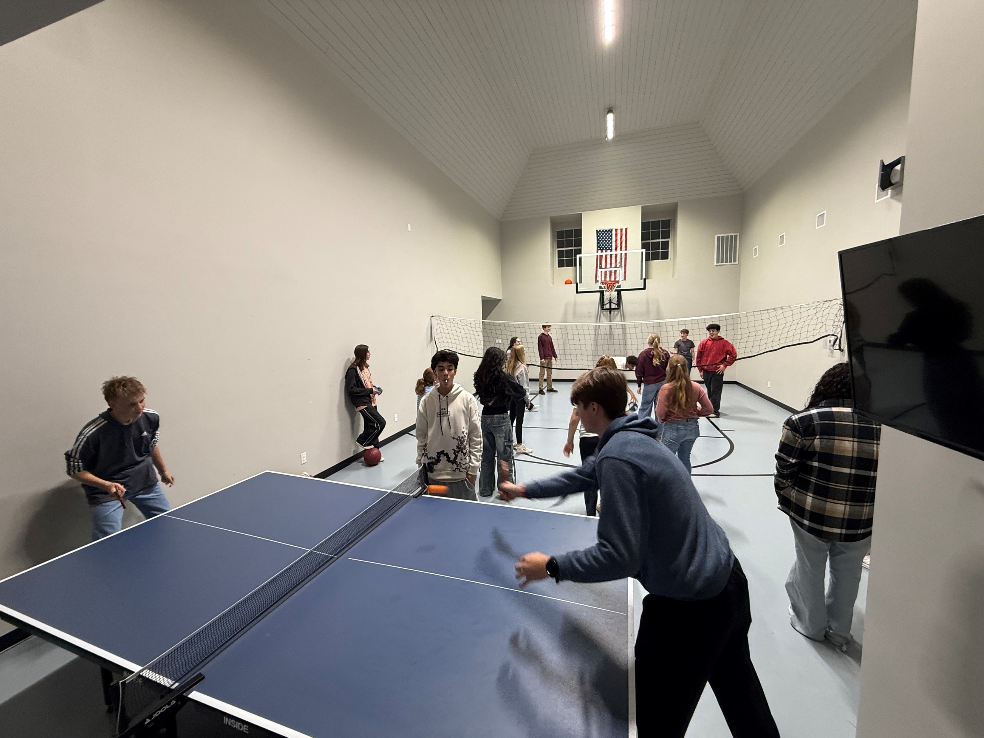 YAF Houston students playing ping pong and volleyball in the game room
