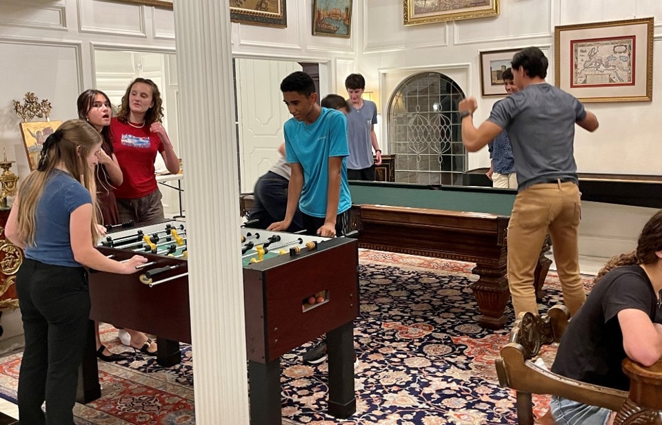 YAF Houston students playing foosball and pool at the estate