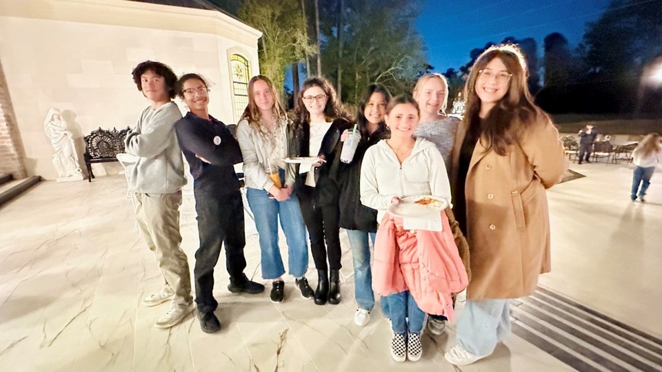YAF Houston students gathered outside at night with food and boba drinks