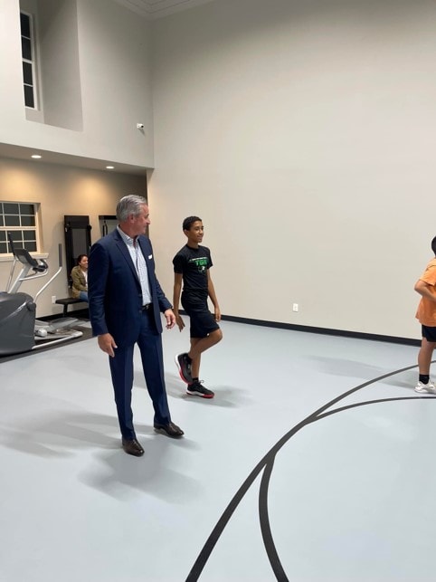 YAF Houston students touring a gym facility with a speaker