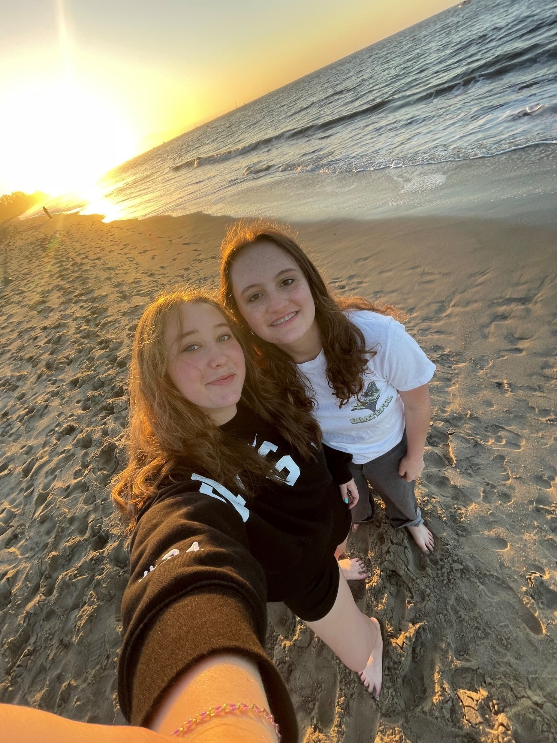 Two YAF Houston students taking a selfie on the Santa Barbara beach at sunset