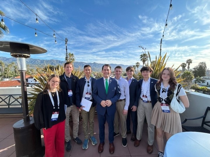 YAF Houston students posing with a speaker on a rooftop in Santa Barbara